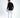 Back view of a man in a black long-sleeve streetwear shirt, white jeans, and black sneakers.