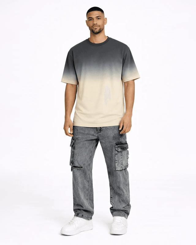 Model wearing Lewis grey washed baggy denim cargo pants with distressed details and a streetwear gradient t-shirt.