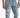 Light blue distressed jeans featuring rips and a chain detail, styled with a casual white shirt.