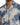 Short-sleeve shirt featuring a textured blue and beige abstract pattern with a button-down front.