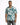 A man wearing a short-sleeve, teal and white patterned shirt, paired with distressed jeans.