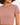 Close-up of a woman wearing a fitted, short-sleeve, dusty rose top with a round neckline.