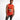 A man wearing a sleeveless orange top with graphic text and images, paired with distressed black jeans.