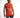 A man wearing a sleeveless bright orange top with graphic prints and distressed gray jeans, posing against a white ba...