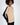 Beige and black ribbed Lilith Sweater featuring shoulder cut-outs and a crew neck on a woman with an afro.