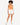 Model wearing an orange bodysuit with a cutout, paired with white shorts and white sneakers.