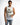 A man wearing a sleeveless white top with a graphic design and distressed denim shorts, posing against a plain backgr...