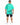 A man wearing a mint green oversized t-shirt with inspirational text printed on the back, paired with denim shorts.