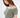 A model showcases a soft, off-the-shoulder, cropped top in a muted green hue with short sleeves.
