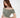 A model poses in a soft, off-the-shoulder, cropped top in a muted green shade, paired with white pants.