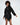 A model showcases a black hooded dress with an unique hemline, emphasizing and style.