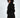 A model with curly hair poses in a black hooded garment featuring unique side cutouts and ring details.