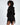 A model with curly hair poses in a black hooded garment featuring unique side cutouts and ring details.