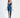 A model poses in a sleek, teal satin dress with a deep neckline and a thigh-high slit, paired with black heels.