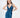A model poses in a deep blue satin dress with a plunging neckline and a thigh-high slit, showcasing elegant draping.