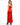 A woman models a sleek red satin dress with a fitted bodice and a thigh-high slit, paired with black heels.