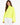 A model wearing a bright neon yellow turtleneck top with wide sleeves, paired with white pants.