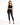 A model poses in a black crochet crop top and fitted black jeans, complemented by strappy black heels.