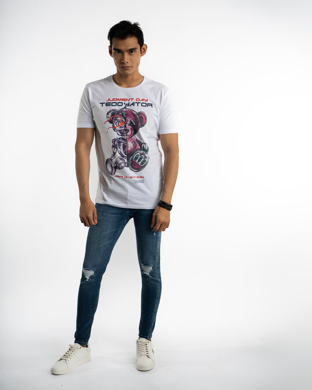 Men's white Teddyator cyborg bear graphic streetwear t-shirt styled with distressed blue jeans and white sneakers.