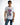 Man in white Teddyator streetwear graphic t-shirt featuring a half-cyborg teddy bear and crew neck, styled with blue jeans.