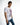 Men's white Teddyator graphic t-shirt with a cyborg teddy bear print, styled with blue jeans for a streetwear look.
