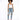 A model poses in a white tank top, distressed light blue jeans, and colorful sneakers against a plain background.