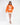 Model in orange The Who graphic sweatshirt and white mini skirt, a knit top for streetwear fashion.