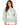 A woman with long, wavy hair wears a light green sweatshirt featuring a large, distressed graphic design.