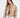Model wearing the Thea beige puffer coat with a high collar and ring-pull zipper in a cropped fit.