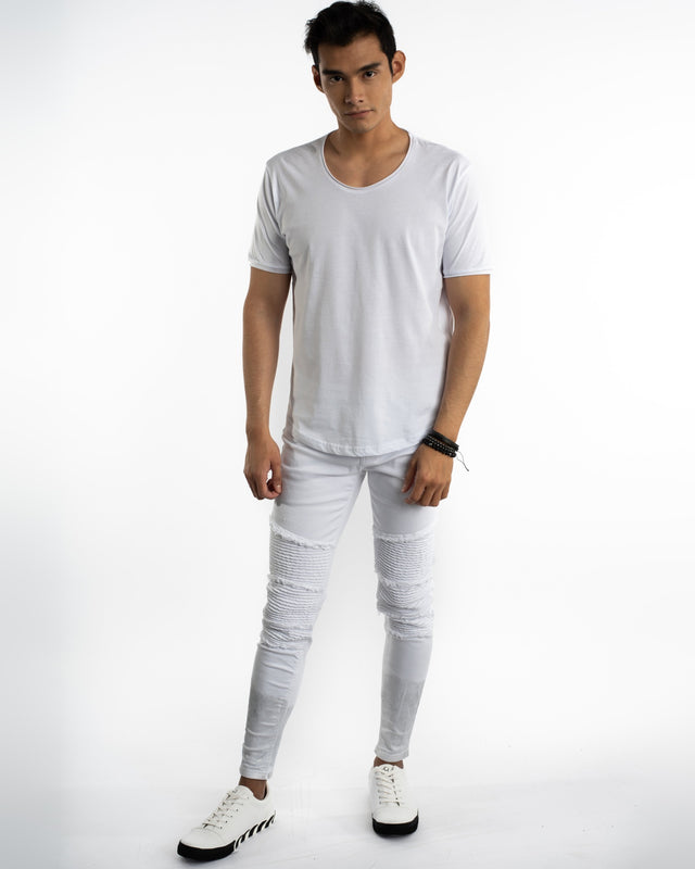 Model wearing Luka white streetwear jeans with moto-ribbed knees, distressed detailing, and white t-shirt.