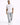 A man walks confidently in distressed light blue cargo jeans paired with a white graphic t-shirt and sneakers.