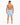 A man stands with his back to the camera, wearing blue and white striped swim shorts and sandals.