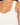 Close-up of a light-colored ribbed top featuring wide straps and a fitted bodice, highlighting a textured design.