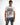 A man wearing a white graphic t-shirt featuring a colorful boombox design and the text "DON'T TOUCH ME! KEEP ON RISING."