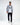 Man wearing Tom Grey Washed Denim Shirt by Carbon over a white graphic tee and black pants.