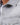 Close-up of Tom Denim Shirt in grey washed fabric featuring metallic snap buttons and a Western-style chest pocket.