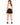 Back view of black sweat shorts worn with a white tank and black sneakers