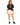 Woman in cream drawstring sweat shorts and a black graphic tee, front view