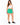 Woman in green sweat shorts and a white tank with black sneakers