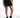 Maddison black high-waisted mini skirt featuring an asymmetrical wrap front and eyelash lace trim at the hem.