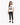 A woman stands wearing a white graphic tee with a zebra print design, paired with black skinny jeans and sneakers.