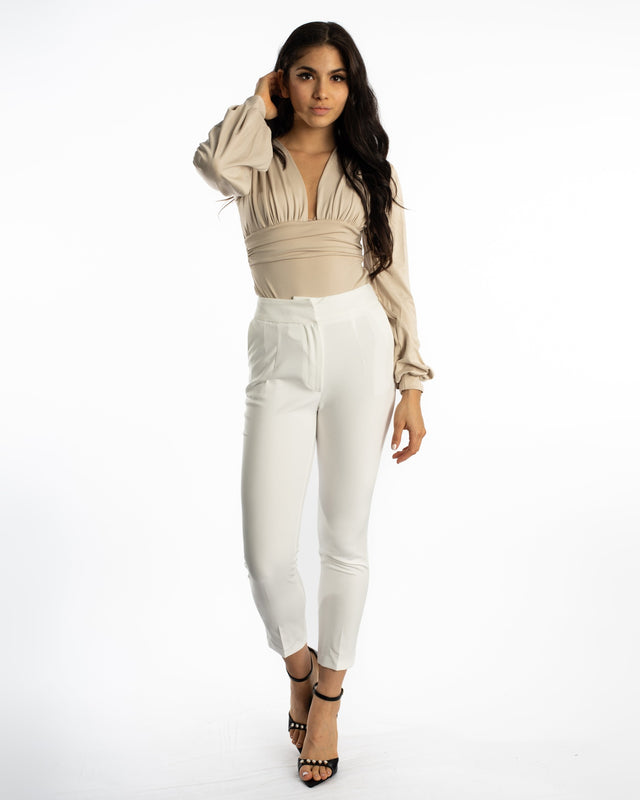 Model wearing Maisie white high-waisted tailored trousers with a beige bodysuit and black heels on a white background.