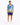 A man stands wearing a colorful short-sleeve shirt with a tropical design and matching shorts, paired with white snea...