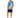 A man stands wearing a colorful short-sleeve shirt with tropical designs and matching shorts, paired with white sneak...