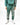 A person wearing a green sweatshirt and matching joggers with silver coral-like designs, paired with white sneakers.