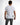 A man is shown from the back wearing a fitted white shirt with gray accents and gray jeans.