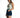 A model poses in a tie-dye tank top and denim shorts, showcasing a casual summer outfit.
