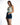 A model poses in a tie-dye tank top and denim shorts, showcasing a casual summer outfit.