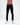 Marcus men's dark blue jeans with five-pocket styling and white sneakers on a studio background.