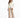 A woman stands confidently in a fitted cream jacket paired with beige wide-leg trousers and black heels.